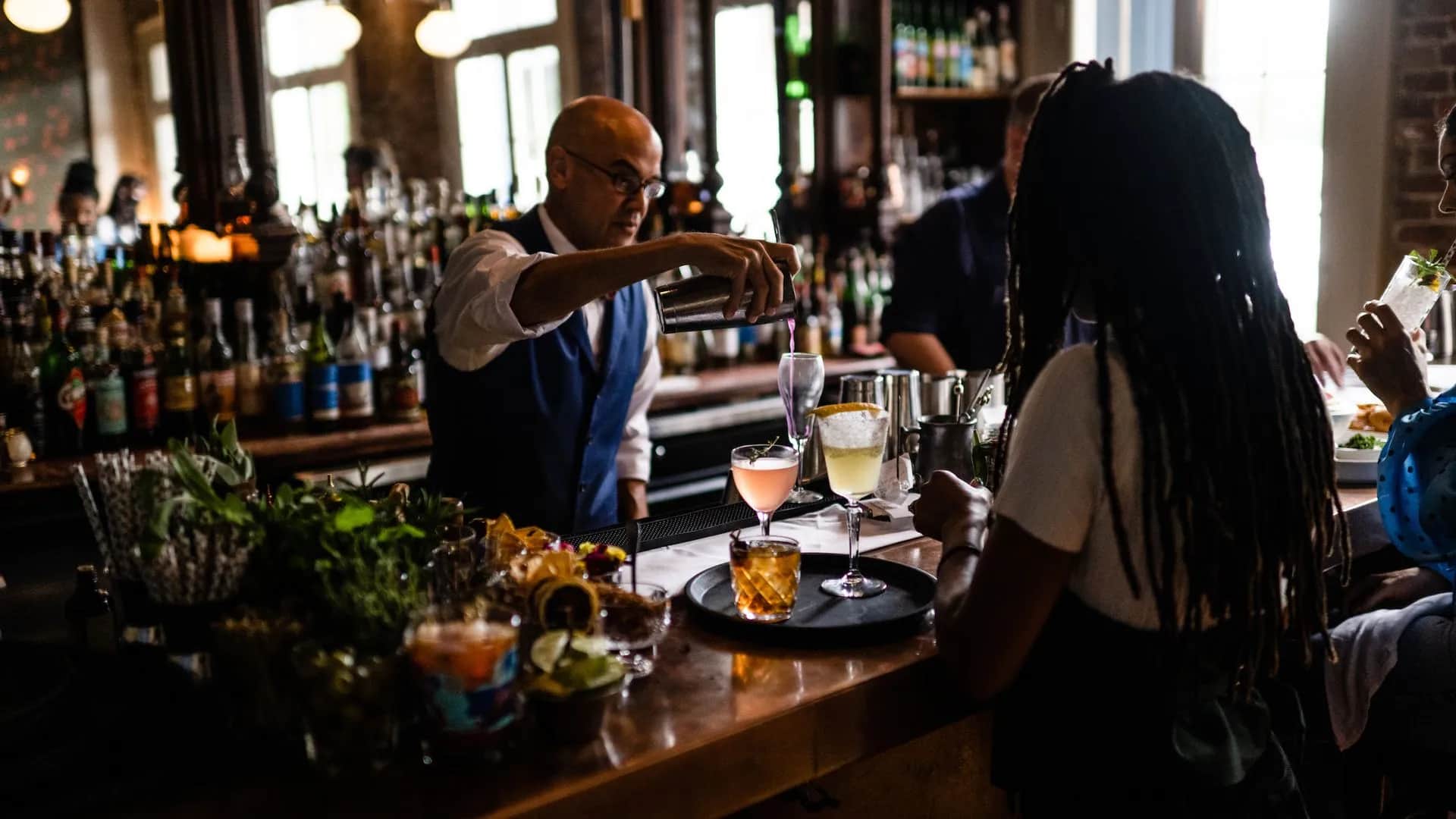 Legendary bartender Chris Hannah pours a cocktail behind the bar at Jewel of the South in the French Quarter.