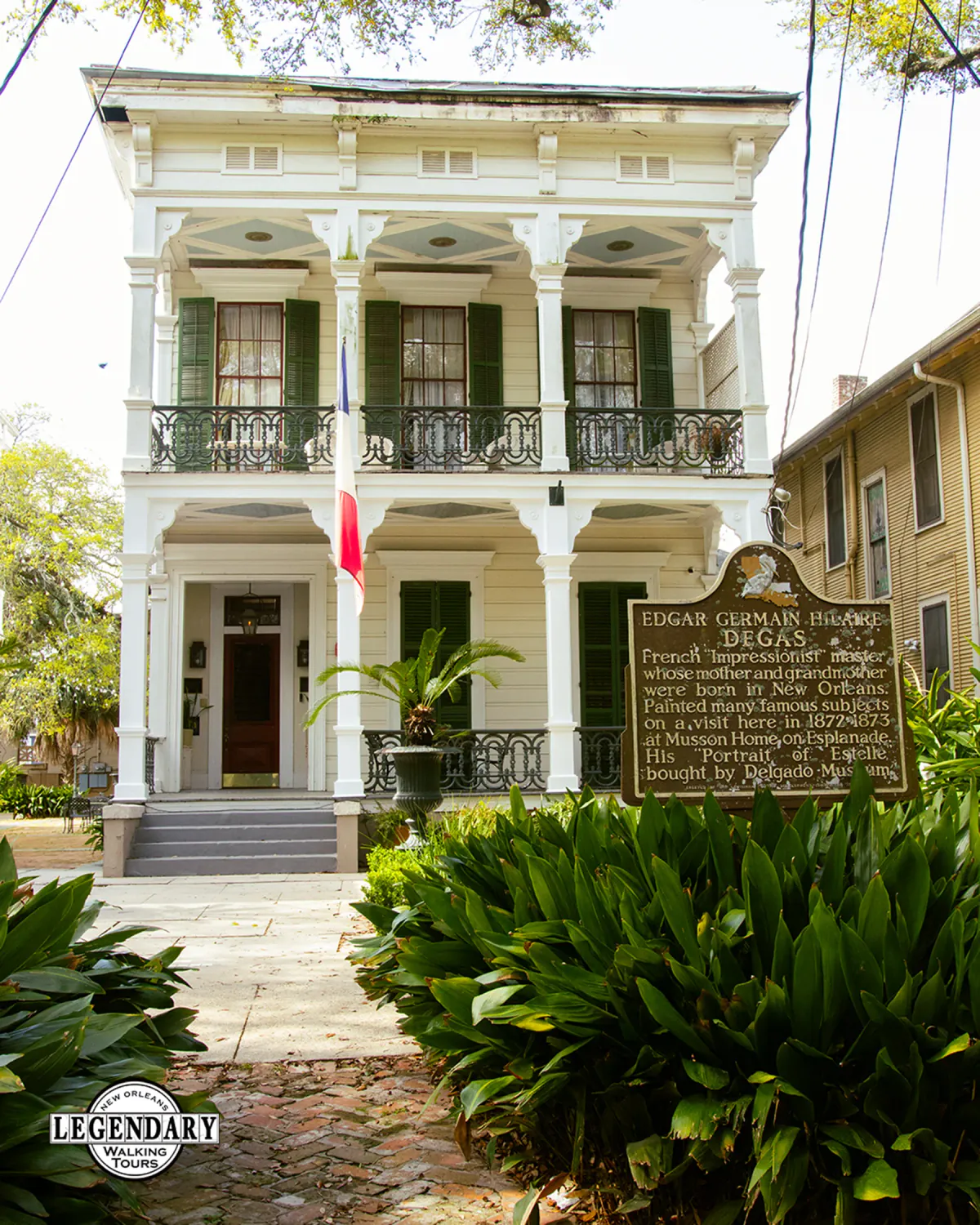 Raised center-hall cottage with cast-iron galleries in New Orleans