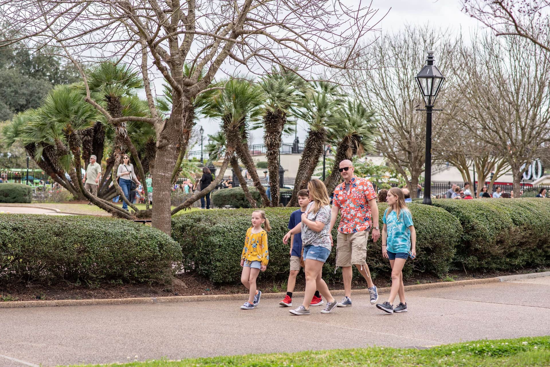 A family taking a walking tour in the French Quarter during winter in New Orleans