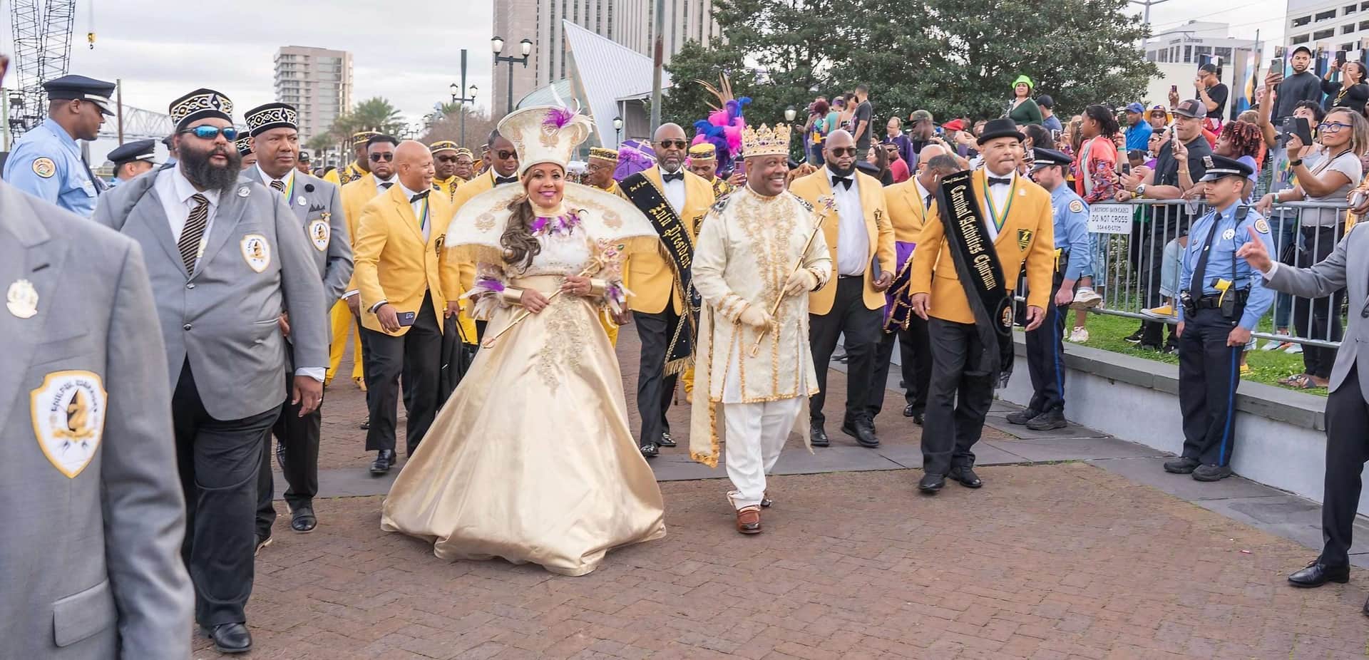 King and Queen of Zulu Lundi Gras Festival walking in a parade with other Zulu Krewe members