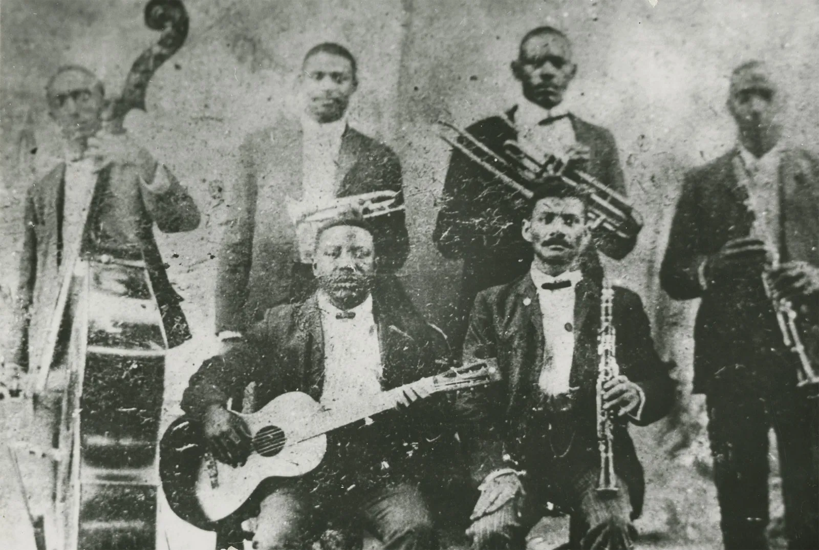 A black and white photo of Buddy Bolden in front of a brass band.